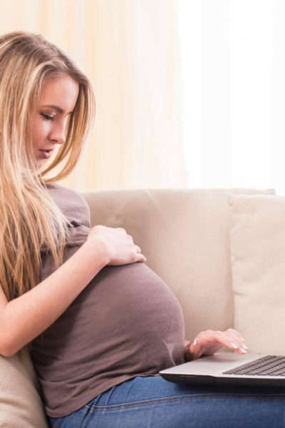 Pregnant Woman on the Couch Registering at Amazon Baby Registry